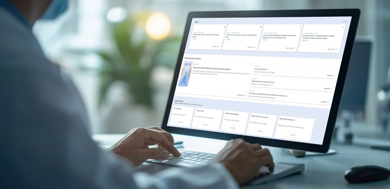 Medical professional wearing a mask types on a laptop showing a hospital dashboard with cards and charts on screen